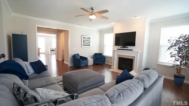 a living room with furniture a fireplace and a flat screen tv