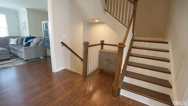 a view of entryway and hall with wooden floor