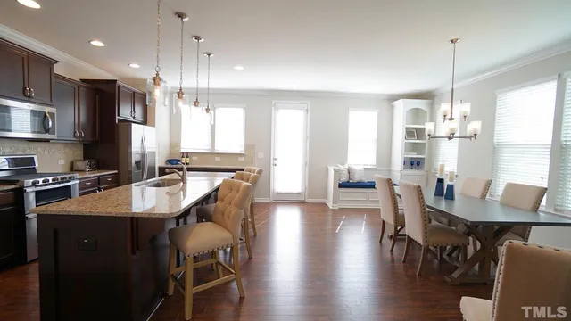 a large kitchen with a table and chairs