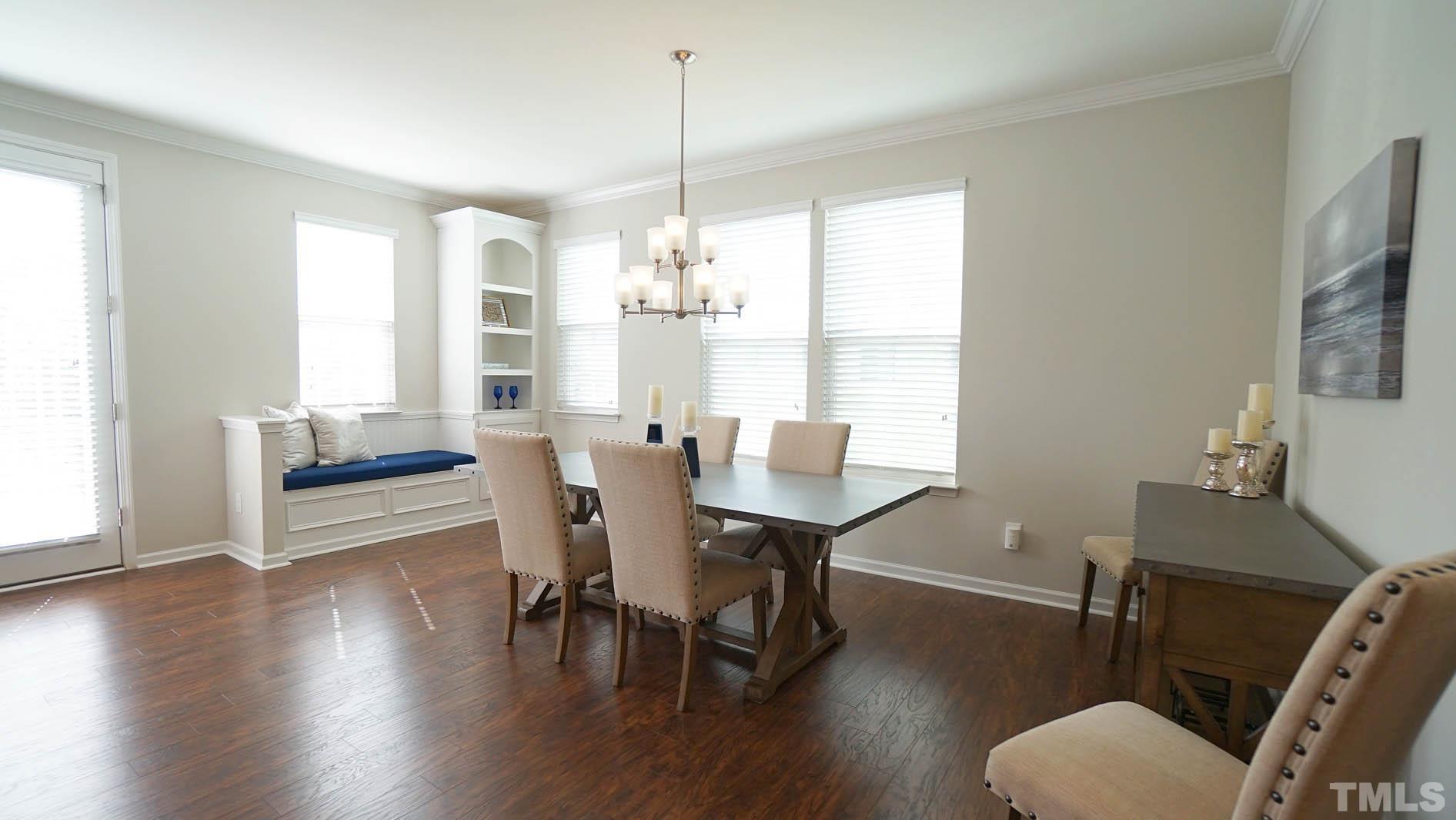 540 Metro Station Apex, NC 27502 - Photo 21 of 45 a view of a dining room with furniture window and wooden floor