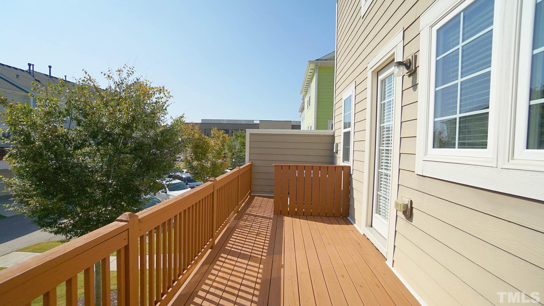540 Metro Station Apex, NC 27502 - Photo 29 of 45 a view of a balcony with wooden floor and fence