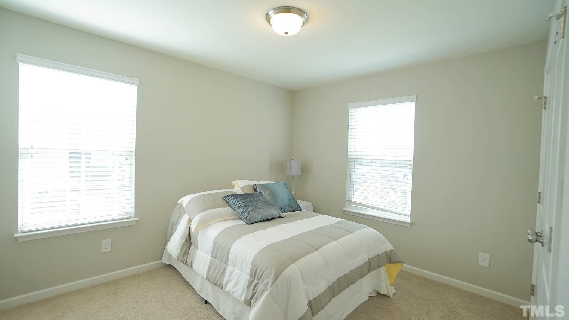 540 Metro Station Apex, NC 27502 - Photo 31 of 45 a bedroom with a bed and a window