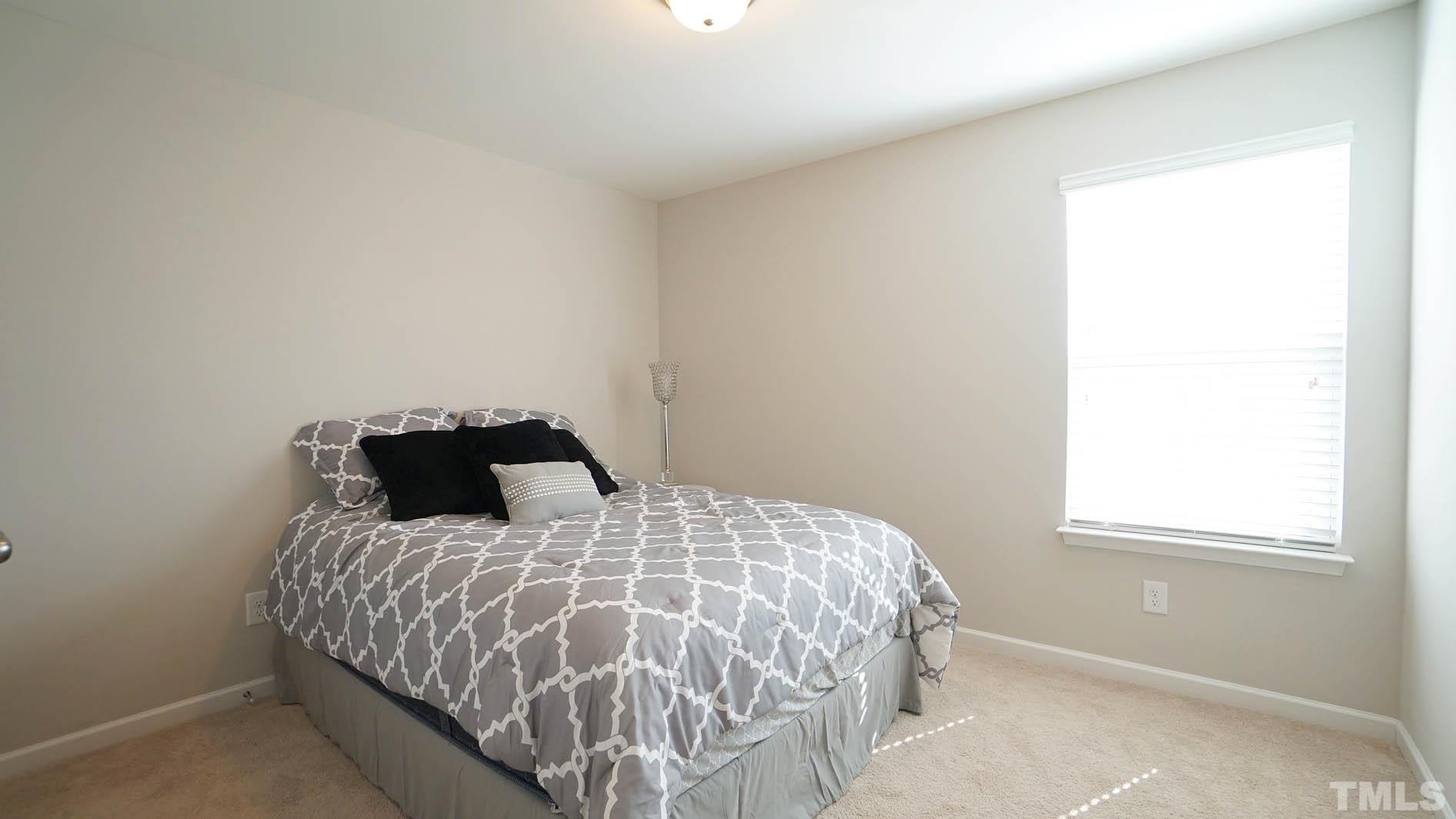 540 Metro Station Apex, NC 27502 - Photo 33 of 45 a bedroom with a bed and a window