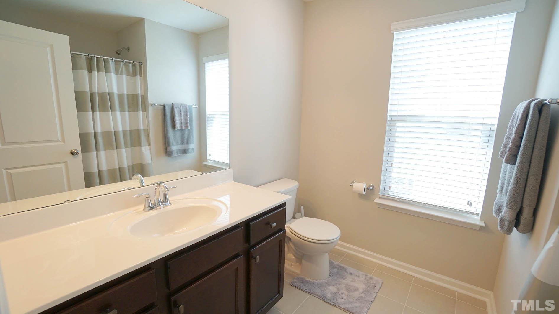 540 Metro Station Apex, NC 27502 - Photo 34 of 45 a bathroom with a sink a toilet and a window
