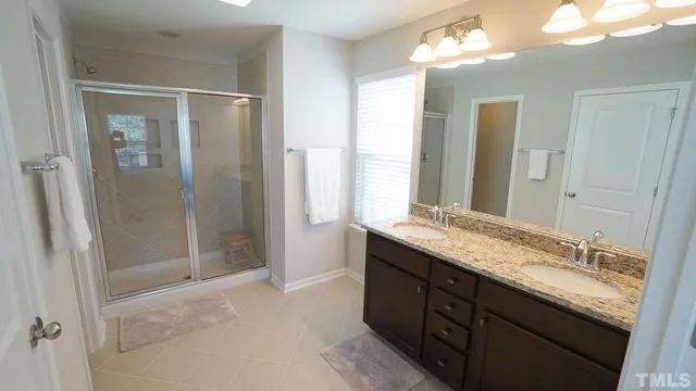 a bathroom with a granite countertop sink mirror and double