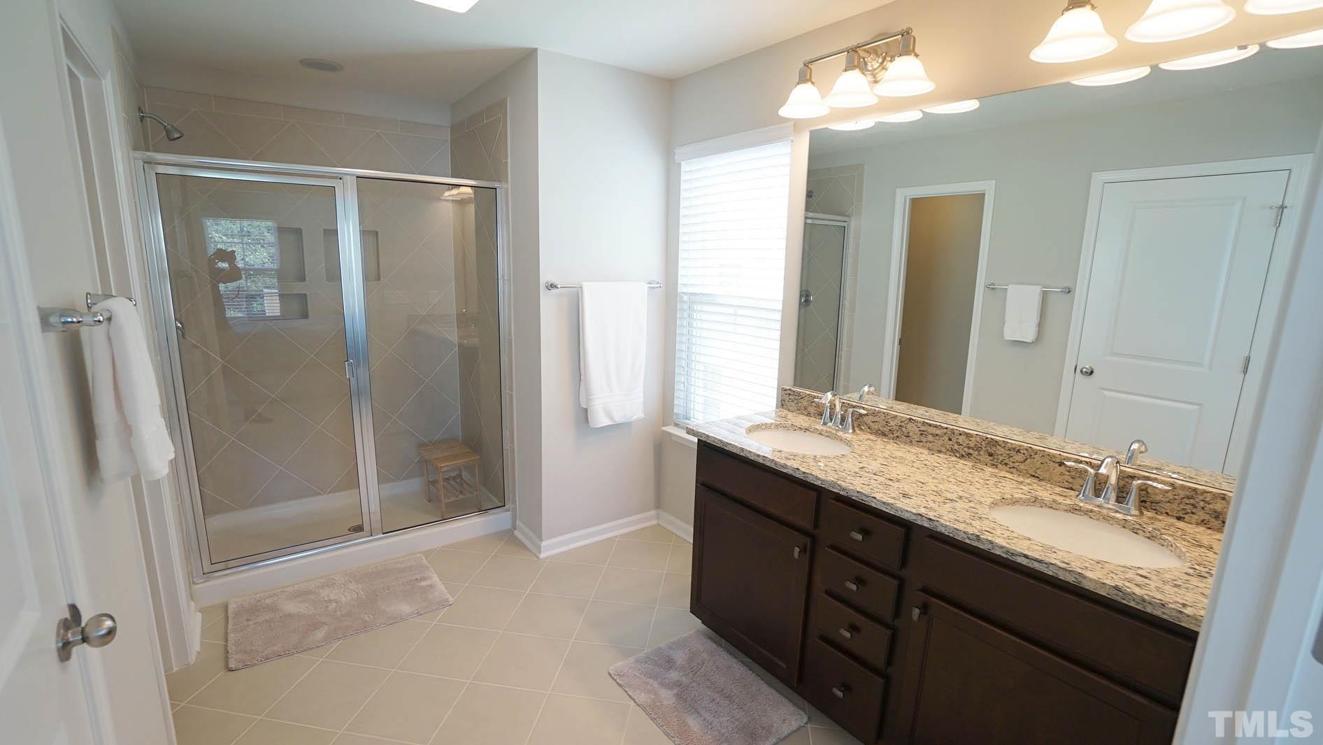 540 Metro Station Apex, NC 27502 - Photo 39 of 45 a bathroom with a granite countertop sink mirror and double