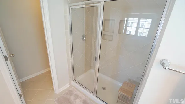 a bathroom with a glass door shower