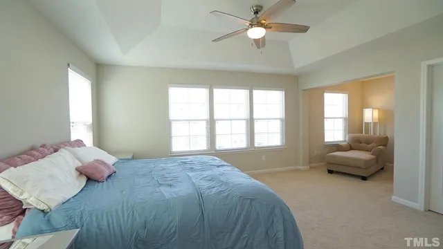 a spacious bedroom with a bed and a window