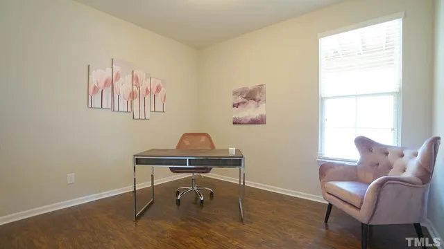a view of a workspace with furniture and a window