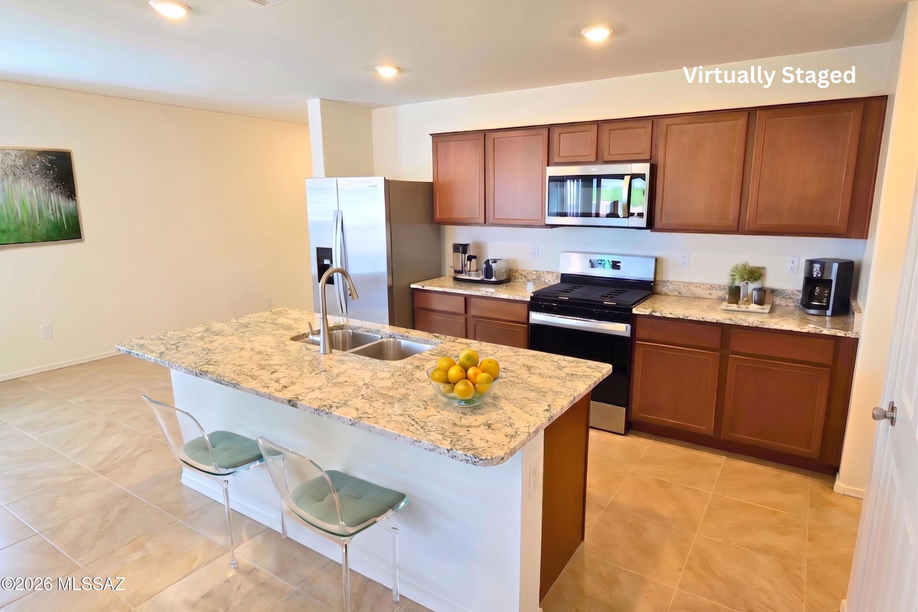 6343 South Rigby Way Tucson, AZ 85746 - Photo 4 of 29 a kitchen with stainless steel appliances granite countertop a sink stove and refrigerator