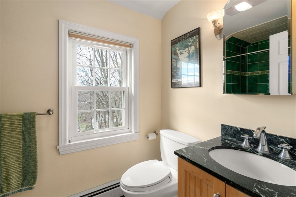 43 Palmer Road Newton, MA 02468 - Photo 17 of 40 a bathroom with a granite countertop toilet a sink and a window