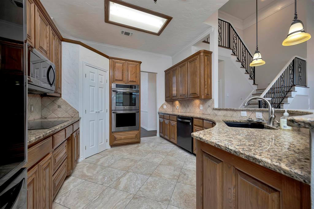5520 White Settlement Road Weatherford, TX 76087 - Photo 14 of 39 a kitchen with stainless steel appliances granite countertop a sink stove and refrigerator
