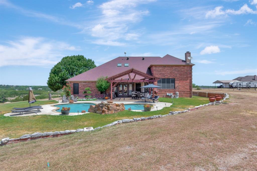 5520 White Settlement Road Weatherford, TX 76087 - Photo 2 of 39 a view of a house with a big yard and a large tree