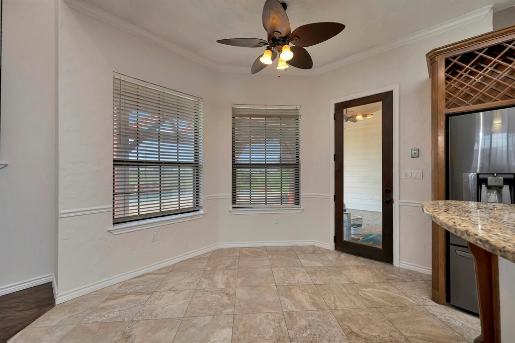 5520 White Settlement Road Weatherford, TX 76087 - Photo 21 of 39 a view of an empty room with a chandelier fan and a window