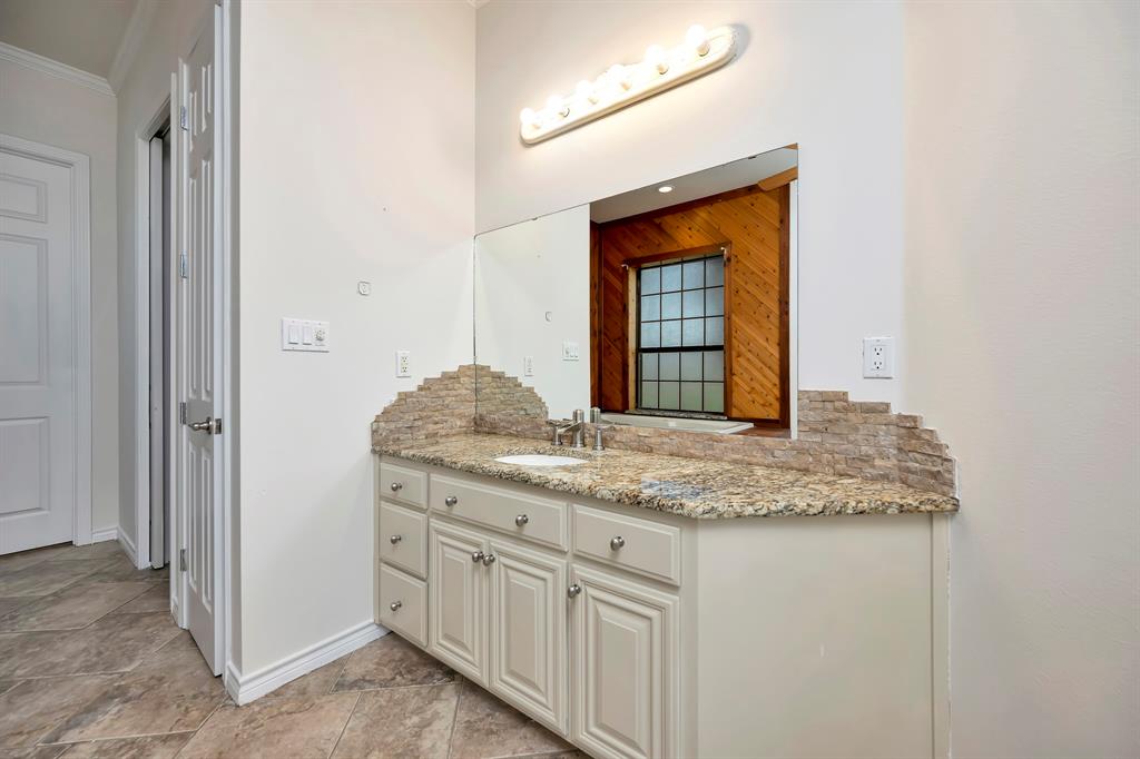 5520 White Settlement Road Weatherford, TX 76087 - Photo 28 of 39 a bathroom with a granite countertop sink and a mirror