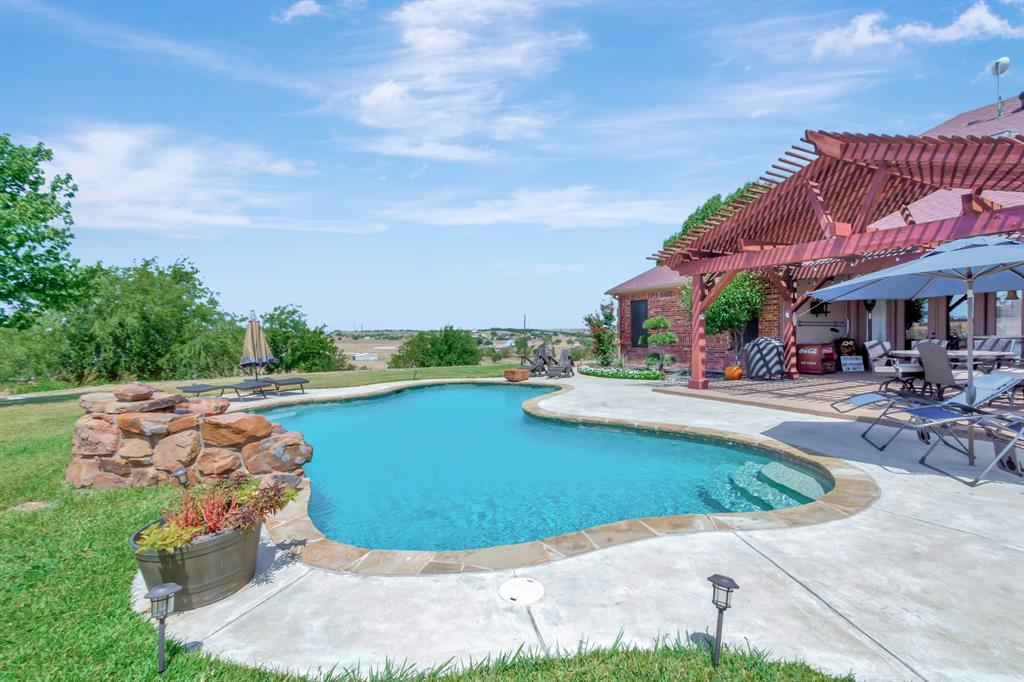 5520 White Settlement Road Weatherford, TX 76087 - Photo 3 of 39 a view of a swimming pool with sitting area