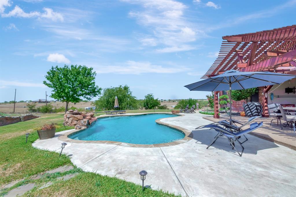 5520 White Settlement Road Weatherford, TX 76087 - Photo 38 of 39 Outdoor pool featuring a pergola, a patio, and a lawn