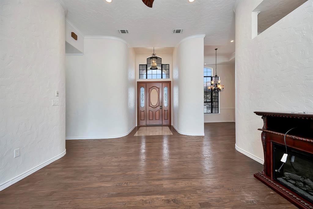 5520 White Settlement Road Weatherford, TX 76087 - Photo 4 of 39 a view of livingroom with hardwood floor and a fireplace