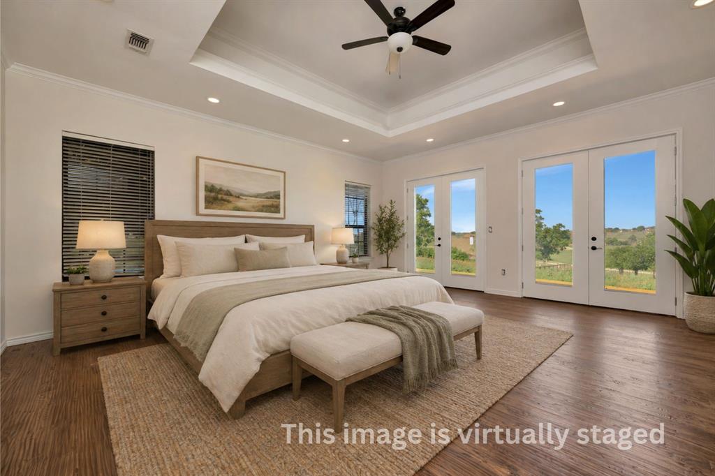 5520 White Settlement Road Weatherford, TX 76087 - Photo 8 of 39 a spacious bedroom with a large bed and a chandelier