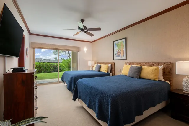 a bedroom with a bed and a television