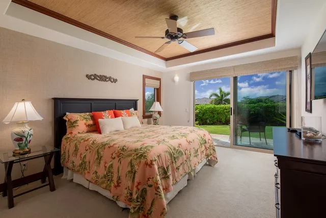 a bedroom with a bed a chandelier and large window