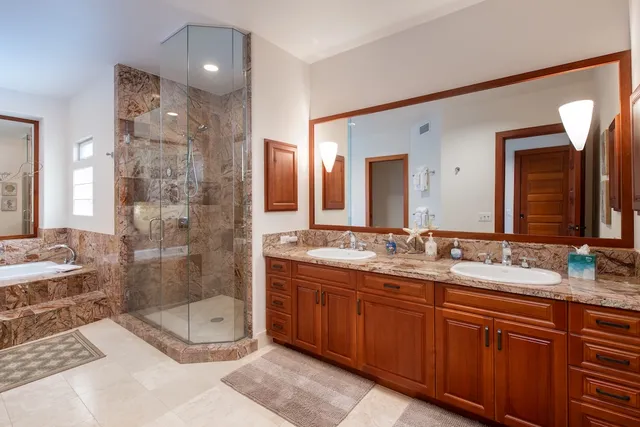 a bathroom with a double vanity sink mirror double and shower