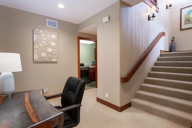 a view of a livingroom with furniture and workspace