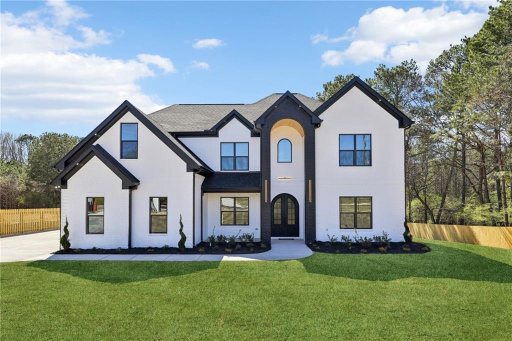a front view of a house with a yard and garage