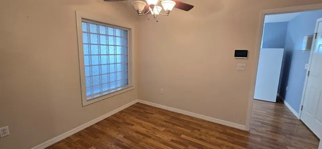 wooden floor in an empty room with a window