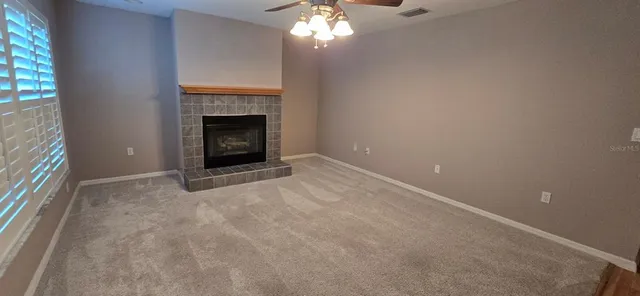a view of an empty room with a fireplace