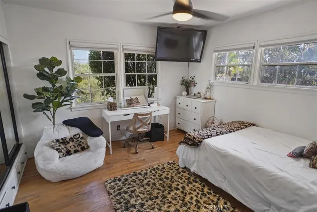 a bedroom with a bed and a potted plant