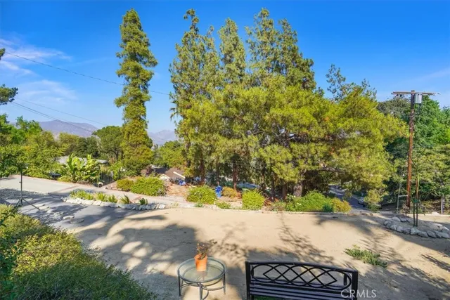a view of a yard with wooden fence