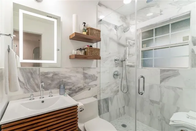 a bathroom with a sink toilet and shower