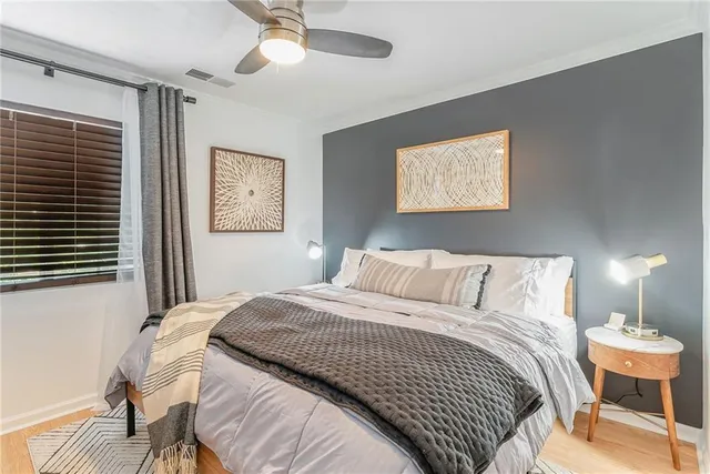 a bedroom with a bed and a lamp