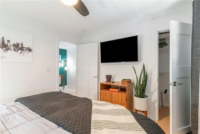 a bedroom with a bed and flat screen tv