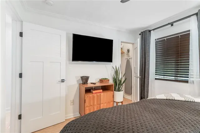 a bedroom with a bed and a flat screen tv