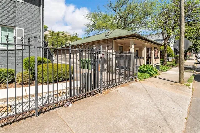 a front view of a house with a garden and pathway