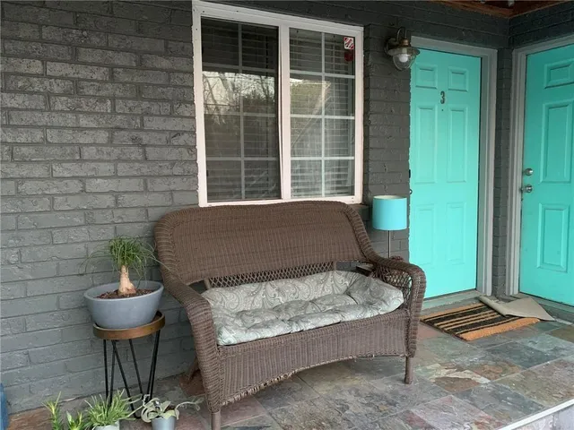 a front view of a house with glass windows and a fence