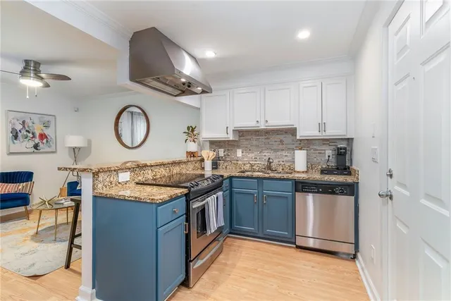 a kitchen with stainless steel appliances granite countertop a stove and a sink
