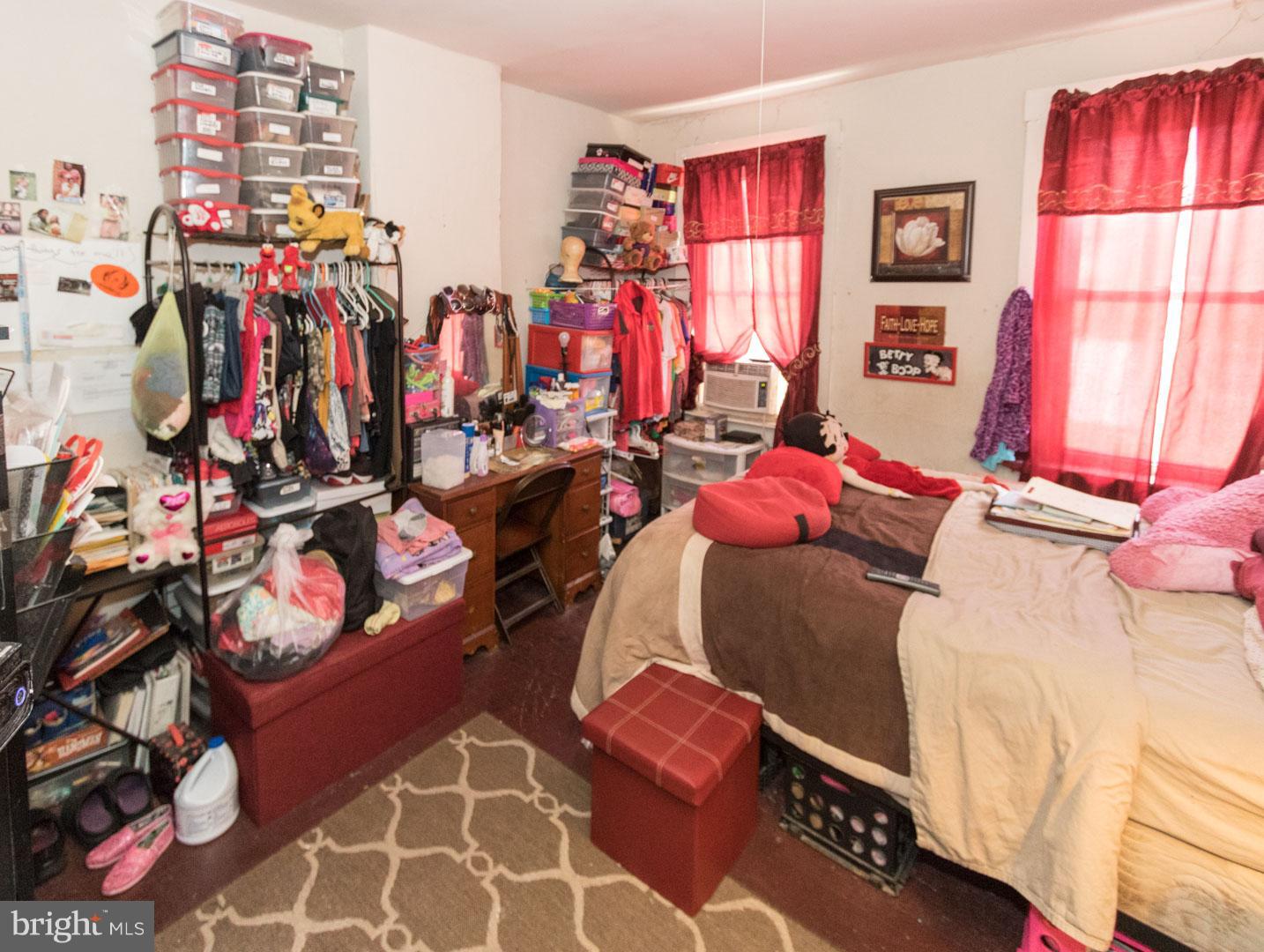2123 East Chase Street Baltimore, MD 21213 - Photo 12 of 12 a view of walk in closet with clothes and shoes