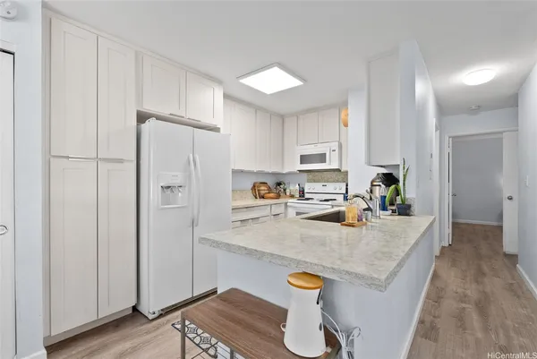 a kitchen with a stove sink and cabinets