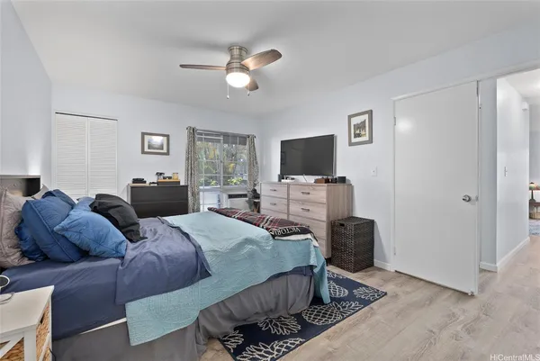 a bedroom with a bed and ceiling fan