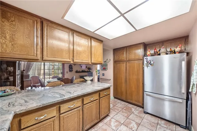 a kitchen with stainless steel appliances granite countertop a refrigerator and a sink