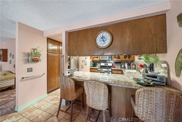 a view of a kitchen with a dining table and chairs