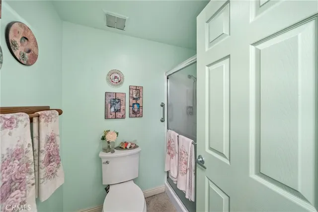 a bathroom with a toilet a sink and a shower curtain