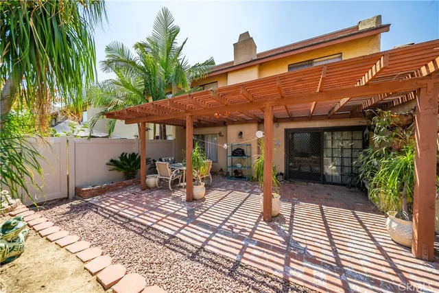 a front view of house with yard outdoor seating and barbeque oven