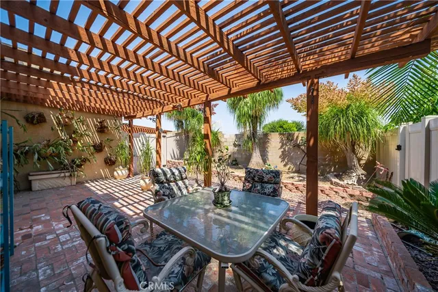 a view of a patio with a table chairs and a potted plant