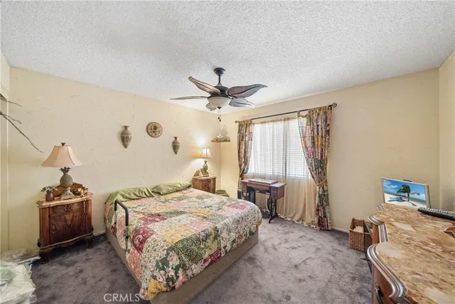 a bedroom with a bed and a tv