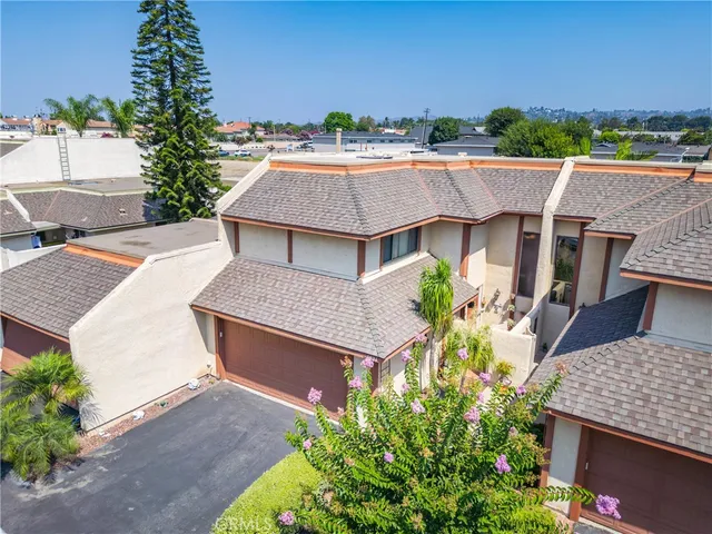 an aerial view of a house with garden space and street view