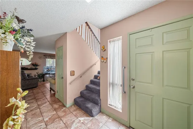 a view of entryway with livingroom and flower pot